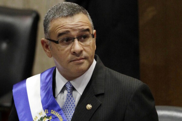 FILE - El Salvador's President Mauricio Funes stands in the National Assembly before speaking to commemorate the anniversary of his third year in office in San Salvador, El Salvador, June 1, 2012. The State Department announced Wednesday, July 19, 2023, it was imposing sanctions on two former Salvadoran presidents including Funes, and dozens of other officials and judges in Central America. (AP Photo/Luis Romero, File)