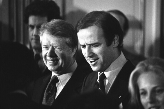 FILE - President Jimmy Carter, left, and Sen. Joseph R. Biden Jr., greet Biden supporters at a reception in Wilmington, Del., Feb. 20, 1978. Former President Donald Trump is running against President Biden, but Trump, the presumptive Republican nominee, keeps bringing up former President Carter. Trump likes to cite the 99-year-old former president as a measuring stick to belittle Biden. (AP Photo)