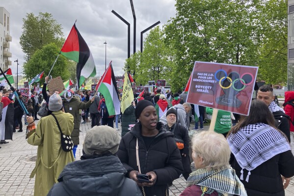 Demonstrators demanding the boycott of Israel during Olympic Games demonstrate outside the Paris Olympic organizing committee headquarters, Tuesday, April 30, 2024 in Saint-Denis, outside Paris. About 300 pro-Palestinian demonstrators took part on the protest. (AP Photo/Alexander Turnbull)