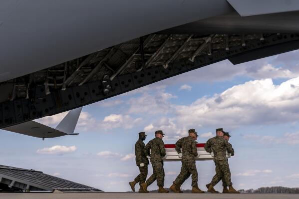 A U.S. Marine Corps carry team moves a transfer case containing the remains of Cpl. Jacob M. Moore of Catlettsburg, Ky., during a casualty return, Friday, March 25, 2022, at Dover Air Force Base. According to the Department of Defense, Moore died March 18, in an Osprey crash during a NATO exercise in Norway. (AP Photo/Andrew Harnik)