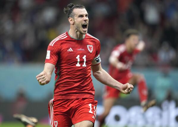 FILE - Wales' Gareth Bale celebrates after scoring his side's opening goal during the World Cup, group B soccer match between the United States and Wales, at the Ahmad Bin Ali Stadium in Doha, Qatar, Monday, Nov. 21, 2022. Gareth Bale is retiring from soccer at age 33 after setting a Wales record with 41 international goals. “My decision to retire from International football has been by far the hardest of my career,” Bale said in a statement Monday, Jan. 9, 2023.(AP Photo/Ashley Landis, File)