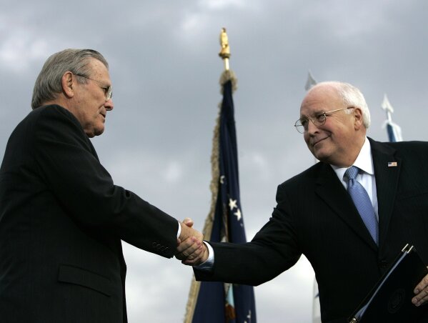 FILE - In this Dec. 15, 2006, file photo, outgoing Defense Secretary Donald H. Rumsfeld, left, shakes hands with Vice President Dick Cheney during an Armed Forces Full Honor Review for Rumsfeld at the Pentagon. All 10 living former secretaries of defense, including Rumsfeld and Cheney, have joined in cautioning against any attempt to use the military in the cause of overturning the November 2020 presidential election.  (AP Photo/Pablo Martinez Monsivais, File)