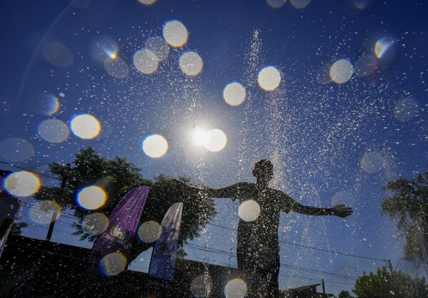 FILE - A youth cools off at the Parque de Agua public water park on a hot summer day in Santiago Chile Jan 31 2024 For the eighth straight month Earth was record hot according to the European climate agencys analysis of January 2024 AP PhotoEsteban Felix File