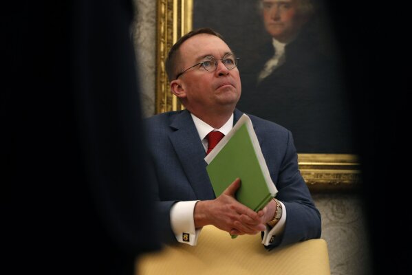 
              FILE - In this Jan. 31, 2019, file photo, aActing White House chief of staff Mick Mulvaney listens as President Donald Trump speaks during a meeting with American manufacturers in the Oval Office of the White House in Washington. As the White House grappled with growing Republican defection against President Donald Trump’s use of an emergency declaration to try to build his promised border wall, his acting White House chief of staff wasn’t on the Hill working former colleagues or at the White House making calls. (AP Photo/Jacquelyn Martin)
            