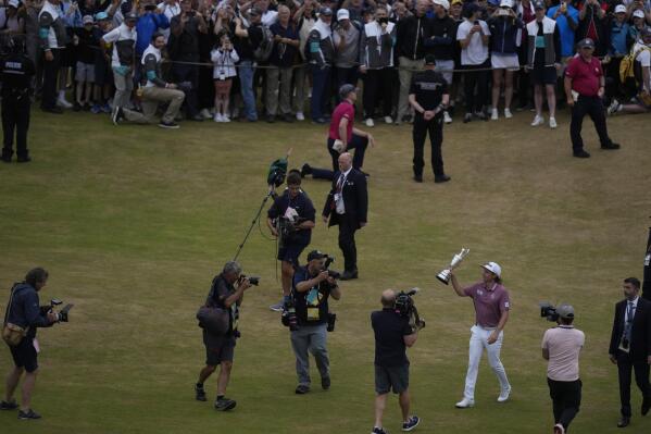FILE - Cameron Smith, of Australia, holds the claret jug trophy after winning the British Open golf championship on the Old Course at St. Andrews, Scotland, Sunday July 17, 2022. Smith had one of the best years in golf with four wins, one of them in LIV Golf. (AP Photo/Alastair Grant, File)