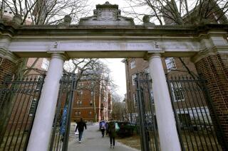 FILE - A gate opens to the Harvard University campus, on Dec. 13, 2018, in Cambridge, Mass. Three Harvard University graduate students said in a federal lawsuit filed Tuesday, Feb. 8, 2022, that the Ivy League school for years ignored complaints about sexual harassment by a renowned professor and allowed him to intimidate students by threatening to hinder their careers. (AP Photo/Charles Krupa, File)