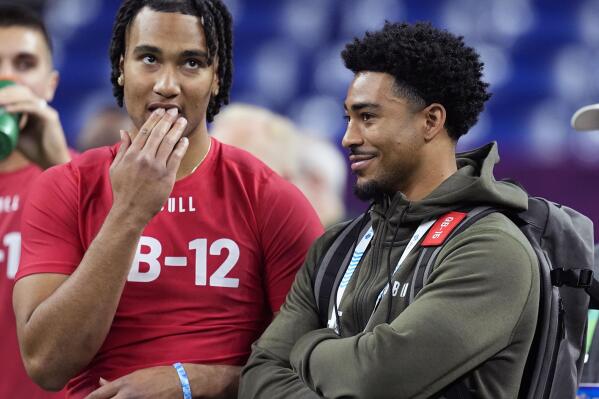 FILE - Ohio State quarterback CJ Stroud, left, talks to Alabama quarterback Bryce Young at the NFL football scouting combine in Indianapolis, Saturday, March 4, 2023. The Carolina Panthers have been on the clock since making a blockbuster trade last month to acquire the No. 1 overall pick in the NFL draft and get their choice of potential franchise quarterbacks. There is still no general consensus on which QB will go first. Stroud or Young? (AP Photo/Darron Cummings, File)