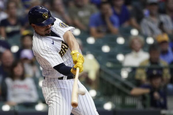 Milwaukee Brewers' Willy Adames hits a two-run home run during the first inning of a baseball game against the Cincinnati Reds, Saturday, Sept. 10, 2022, in Milwaukee. (AP Photo/Aaron Gash)