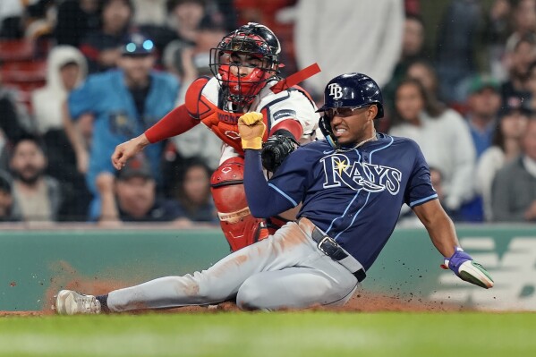 Tampa Bay Rays' Richie Palacios scores against Boston Red Sox catcher Connor Wong on a single by Jose Siri during the sixth inning of a baseball game, Wednesday, May 15, 2024, in Boston. (Ǻ Photo/Michael Dwyer)