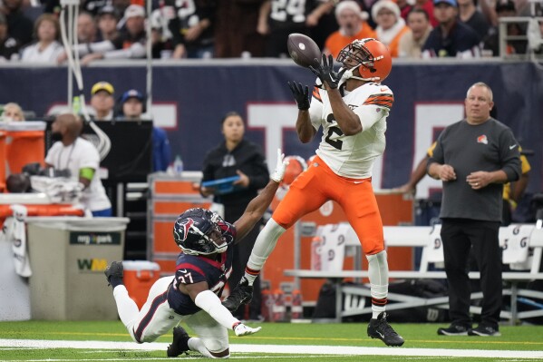 Cleveland Browns wide receiver Amari Cooper (2) hauls in a pass for a touchdown as Houston Texans cornerback D'Angelo Ross (37) defends during the first half of an NFL football game Sunday, Dec. 24, 2023, in Houston. (AP Photo/Eric Christian Smith)