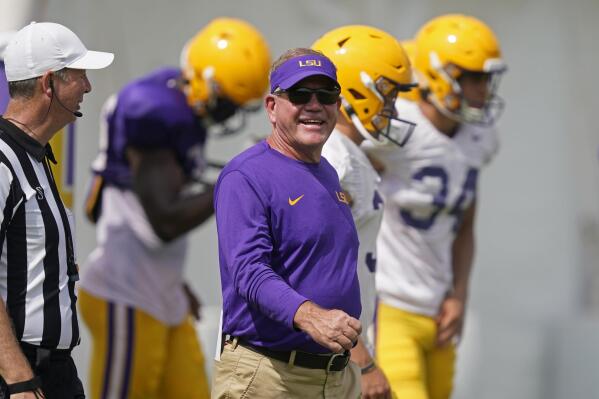 LSU head coach Brian Kelly smiles as he walks across the field during NCAA college football practice in Baton Rouge, La., Wednesday, Aug. 17, 2022. (AP Photo/Gerald Herbert)