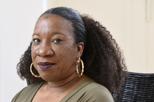 FILE - Tarana Burke, founder and leader of the #MeToo movement, sits in her home in Baltimore on Tuesday, Oct. 13, 2020. (AP Photo/Steve Ruark, File)
