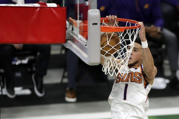Phoenix Suns Devin Booker dunks during the second half of an NBA basketball game against the Milwaukee Bucks Monday, April 19, 2021, in Milwaukee. (AP Photo/Aaron Gash)