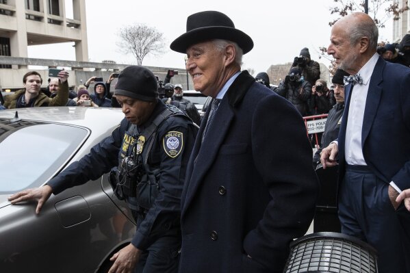 Roger Stone, center, departs federal court in Washington, Thursday, Feb. 20, 2020. President Donald Trump loyalist and ally, Roger Stone was sentenced to over three years in federal prison, following an extraordinary move by Attorney General William Barr to back off his Justice Department's original sentencing recommendation. The sentence came amid President Donald Trump's unrelenting defense of his longtime confidant that led to a mini-revolt inside the Justice Department and allegations the president interfered in the case. (AP Photo/Alex Brandon)