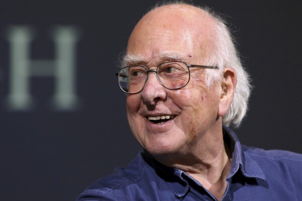 FILE - Britain's Professor Peter Higgs smiles during a press conference in Edinburgh, Scotland, on Oct. 11, 2013. The University of Edinburgh says Nobel prize-winning physicist Peter Higgs, who proposed the existence of the Higgs boson particle, has died at 94. Higgs predicted the existence of a new particle — the so-called Higgs boson — in 1964. But it would be almost 50 years before the particle’s existence could be confirmed at the Large Hadron Collider. Higgs won the 2013 Nobel Prize in Physics for his work, alongside Francois Englert of Belgium. (AP Photo/Scott Heppell, File)