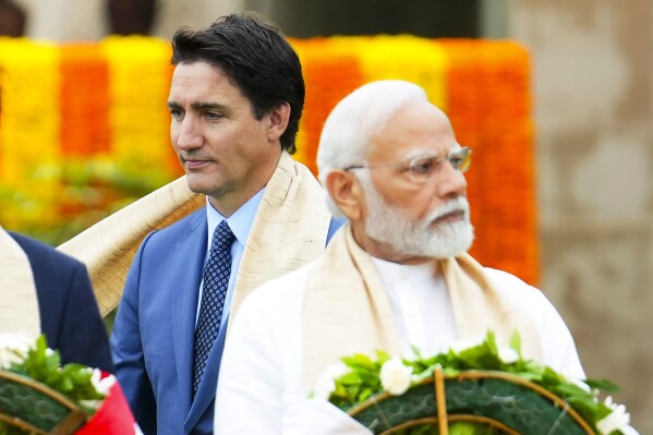 FILE - Canada's Prime Minister Justin Trudeau, left, walks past Indian Prime Minister Narendra Modi as they take part in a wreath-laying ceremony at Raj Ghat, Mahatma Gandhi's cremation site, during the G20 Summit in New Delhi, Sunday, Sept. 10, 2023. Trudeau said that Canada wasn't looking to escalate tensions, but asked India on Tuesday, Sept. 19, to take the killing of a Sikh activist seriously after India called accusations that the Indian government may have been involved absurd.(Sean Kilpatrick/The Canadian Press via AP, File)