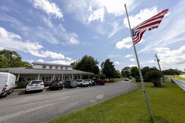 The Us Flag flies at half mast Sunday, June 20, 2021, in Camp Hill, Ala.,  at the Alabama Sheriff's Girls Ranch which suffered a loss of life when their van was involved in a multiple vehicle accident Saturday, resulting in eight people in the van perishing. (AP Photo/Vasha Hunt)