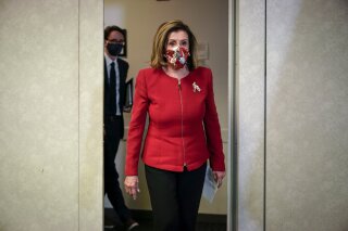 Speaker of the House Nancy Pelosi, D-Calif., arrives to talk to reporters about Election Day results in races for the House of Representatives, at Democratic National Committee headquarters in Washington, Tuesday, Nov. 3, 2020. (AP Photo/J. Scott Applewhite, Pool)