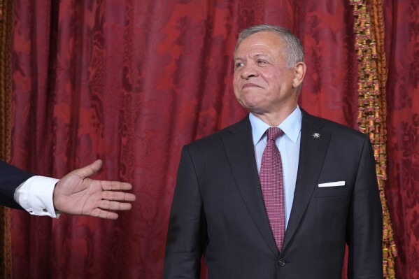 FILE - Jordan's King Abdullah II poses for photos before a reception and lunch at the Royal Palace in Madrid, Spain, on June 19, 2023. The King of Jordan approved a bill Saturday, Aug. 12, 2023, to punish online speech deemed harmful to national unity, according to the Jordanian state news agency, legislation that has drawn accusations from human rights groups of a new crackdown on free expression in a country where censorship and repression are increasingly common.(AP Photo/Paul White, Pool)