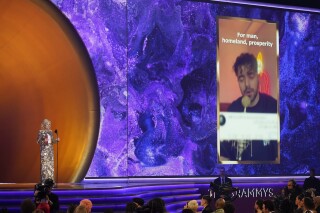 FILE - First lady Jill Biden accepts the award for best song for social change on behalf of Shervin Hajipour for "Baraye" at the 65th annual Grammy Awards on Feb. 5, 2023, in Los Angeles. The Iranian singer who won a Grammy presented by U.S. President Joe Biden's wife said Friday, March 1, 2024, that he had been sentenced to over three years in prison over his anthem supporting the 2022 protests over the death of Mahsa Amini. (AP Photo/Chris Pizzello, File)