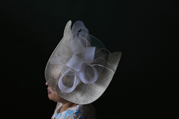 A race fan walk through a tunnel at Churchill Downs before the 151st running of the Kentucky Oaks horse race Friday, May 2, 2025, in Louisville, Ky. (AP Photo/Brynn Anderson)