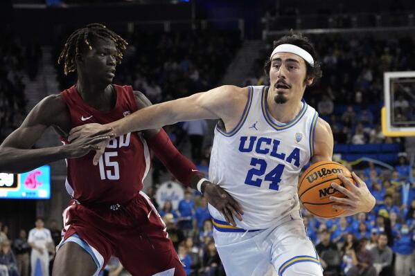 UCLA guard Jaime Jaquez Jr., right, drives by Washington State center Adrame Diongue during the second half of an NCAA college basketball game Saturday, Feb. 4, 2023, in Los Angeles. (AP Photo/Mark J. Terrill)