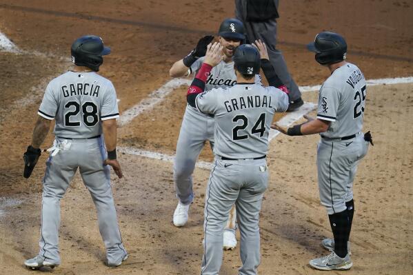 Chicago White Sox's Danny Mendrick, center back, is greeted after his grand slam off Minnesota Twins pitcher Derek Law in the fifth inning of a baseball game, Monday, May 17, 2021, in Minneapolis. (AP Photo/Jim Mone)