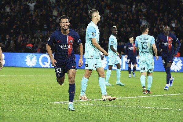 PSG's Warren Zaire-Emery, left, celebrates after scoring his side's second goal during the French League One soccer match between Paris Saint Germain and Montpellier at Parc des Princes stadium in Paris, France, Friday, Oct. 3, 2023. (AP Photo/Aurelien Morissard)