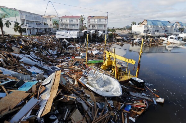 FILE - A boat sits amidst debris in the aftermath of Hurricane Michael in Mexico Beach, Fla. Oct. 11, 2018. FEMA announced Friday, Jan. 19, 2024, it is making changes to its program that helps those who survive wildfires, hurricanes and other natural disasters. The changes are designed to simplify and speed up the process for disaster survivors to get help, including include money for under-insured homeowners, a streamlined application process, and assistance for disaster survivors with disabilities. (AP Photo/Gerald Herbert, File)