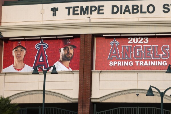 After the Los Angeles Dodgers signing of former Los Angeles Angels player Shohei Ohtani, left, his image still adorns the Angels' Tempe Diablo Stadium, sharing the prominent spot with pitcher Patrick Sandoval at the spring training home of the Angels, Monday, Dec. 11, 2023, in Tempe, Ariz. The Angels have already removed the Ohtani photo banner at the Angels regular season stadium. (AP Photo/Ross D. Franklin)
