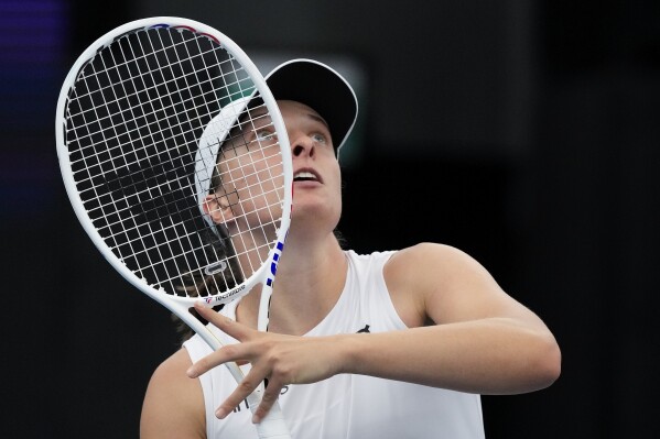 Poland's Iga Swiatek plays a forehand return to Caroline Garcia of France during their United Cup semifinal tennis match in Sydney, Australia, Saturday, Jan. 6, 2024. (AP Photo/Mark Baker)
