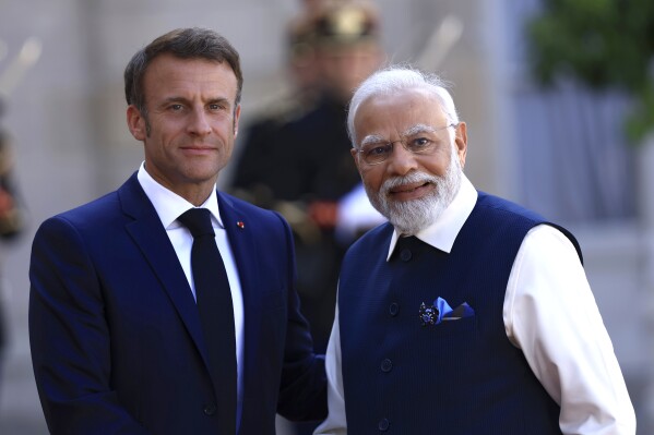 FILE - Indian Prime Minister Narendra Modi, right, and French President Emmanuel Macron pose before their talks at the Elysee Palace in Paris, Friday, July 14, 2023. India has invited French President Emmanuel Macron to be the chief guest at the country's national day celebrations next month, in what Macron's office described Friday Dec.22, 2023 as 