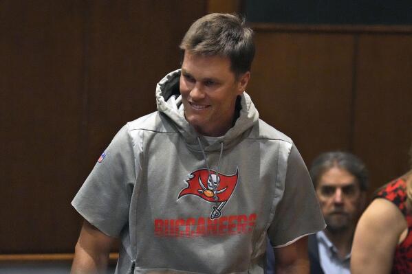 Tampa Bay Buccaneers quarterback Tom Brady smiles as he arrives for an NFL football news conference for new head coach Todd Bowles Thursday, March 31, 2022, in Tampa, Fla. (AP Photo/Chris O'Meara)
