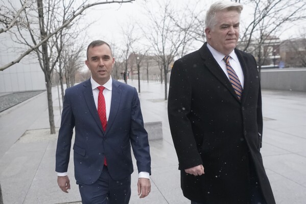 Former Delta Air Lines pilot Jonathan J. Dunn, left, walks with his attorney following his first federal court appearance Thursday, Jan. 4, 2024, in Salt Lake City. Dunn, who was the first officer, or co-pilot, threatened to shoot the captain during a heated argument in the cockpit over whether to change course to accommodate a passenger's medical issue. (AP Photo/Rick Bowmer)