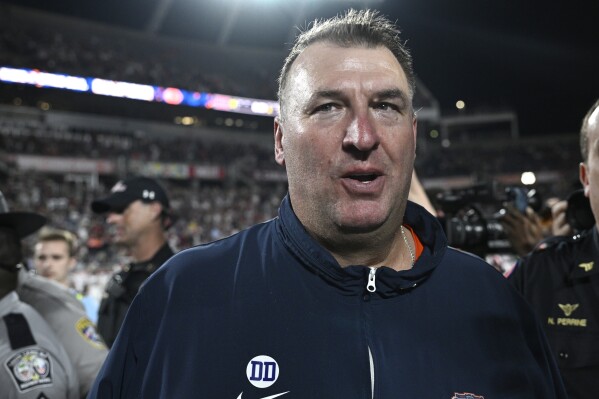 Illinois head coach Bret Bielema walks on the field after a win against South Carolina in the Citrus Bowl NCAA college football game, Tuesday, Dec. 31, 2024, in Orlando, Fla. (AP Photo/Phelan M. Ebenhack, File)