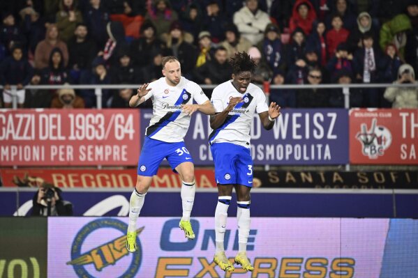 Inter's Yann Aurel Bisseck, right, celebrates scoring during the Serie A soccer match between Bologna and Inter FC at Renato Dall'Ara Stadium, Bologna, Italy, Saturday March 9, 2024. (Massimo Paolone/LaPresse via AP)