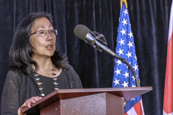 Voice of America Deputy Director Sandy Sugawara speaks during her swearing-in ceremony on May 2, 2016, in Washington. Amanda Bennett, the director of Voice of America and her deputy Sandy Sugawara resigned Monday, June 15, 2020, following recent clashes with the Trump administration. The pair announced they were leaving the organization as Trump ally and conservative filmmaker Michael Pack takes over leadership of the agency that oversees VOA. (George Mackenzie/Voice of America via AP)