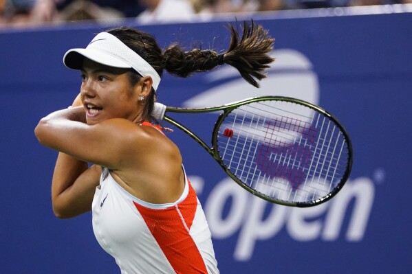 FILE - Emma Raducanu, of Britain, returns a shot to Alize Cornet, of France, during the first round of the US Open tennis championships, Aug. 30, 2022, in New York. (AP Photo/Frank Franklin II, File)