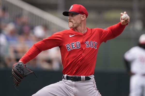 FILE - Boston Red Sox pitcher Cam Booser throws in the fourth inning of a spring training baseball game against the Minnesota Twins in Fort Myers, Fla., March 6, 2024. The Red Sox called up the 31-year-old Booser to the major leagues for the first time Friday, April 19, 2024. (AP Photo/Gerald Herbert, File)