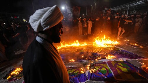 Supporters of Shiite Muslim leader Moqtada Sadr burn rainbow flags, during a demonstration in Sadr City, in response to the burning of Quran in Sweden, Baghdad, Iraq, Wednesday, July 12, 2023. (AP Photo/Hadi Mizban)