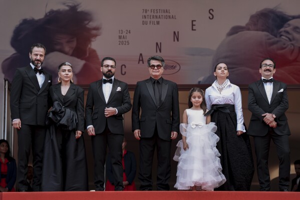 Ebrahim Azizi, from left, Mariam Afshari, Majid Panahi, director Jafar Panahi, Delnaz Najafi, Hadis Pakbaten, and Vahid Mobseri pose for photographers upon arrival at the premiere of the film 'It was just an accident' at the 78th international film festival, Cannes, southern France, Tuesday, May 20, 2025. (Photo by Lewis Joly/Invision/AP)