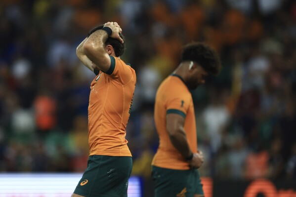 Australia's Ben Donaldson, left, and Australia's Rob Valetini react at the end of the Rugby World Cup Pool C match between Australia and Fiji at the Stade Geoffroy Guichard in Saint-Etienne, France, Sunday, Sept. 17, 2023. (AP Photo/Aurelien Morissard)