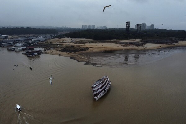A boat is stuck in the Negro River during a drought in Manaus, Amazonas state, Brazil, Monday, Oct. 16, 2023. The Amazon’s second largest tributary on Monday reached its lowest level since official measurements began near Manaus more than 120 years ago. (AP Photo/Edmar Barros)