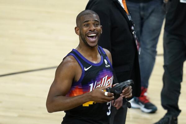 Phoenix Suns guard Chris Paul smiles at the crowd after Game 1 of basketball's NBA Finals against the Milwaukee Bucks, Tuesday, July 6, 2021, in Phoenix. The Suns defeated the Bucks 118-105. (AP Photo/Ross D. Franklin)