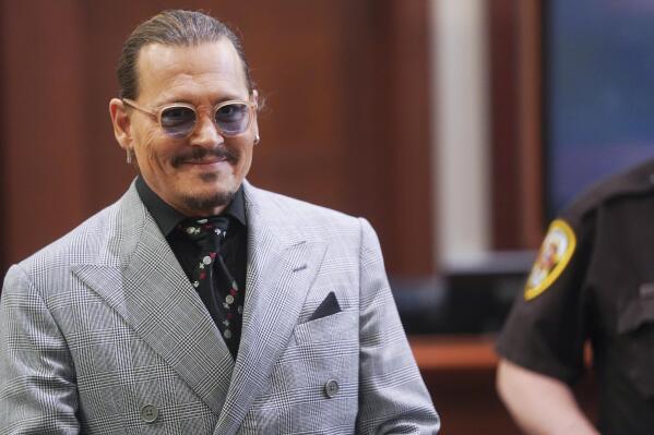 Actor Johhny Depp returns from a break at the Fairfax County Circuit Courthouse in Fairfax, Va., Thursday, May 19, 2022. Actor Johnny Depp sued his ex-wife Amber Heard for libel in Fairfax County Circuit Court after she wrote an op-ed piece in The Washington Post in 2018 referring to herself as a "public figure representing domestic abuse." (Shawn Thew/Pool Photo via AP)