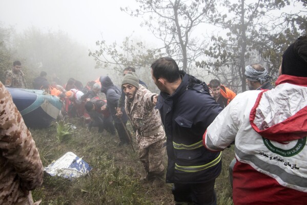 In this photo provided by Moj News Agency, rescue team members work at the scene of a crash of a helicopter carrying Iranian President Ebrahim Raisi in Varzaghan in northwestern Iran, Monday, May 20, 2024. Raisi, the country’s foreign minister and several other officials were found dead on Monday, hours after their helicopter crashed in a foggy, mountainous region of the country’s northwest, state media reported. (Azin Haghighi, Moj News Agency via AP)