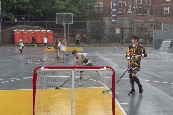 FILE - Kids play ball hockey at an NHL Street event, June 17, 2023, in Boston. The National Hockey League is trying to build on its first foray into the Southern Hemisphere — two preseason games between the Los Angeles Kings and Arizona Coyote on the weekend — by expanding its NHL Street Hockey program to Australia. The program is designed for children ages 6 to 16 and will eventually be instituted into some schools in Victoria state. (AP Photo/Jimmy Golen, File)