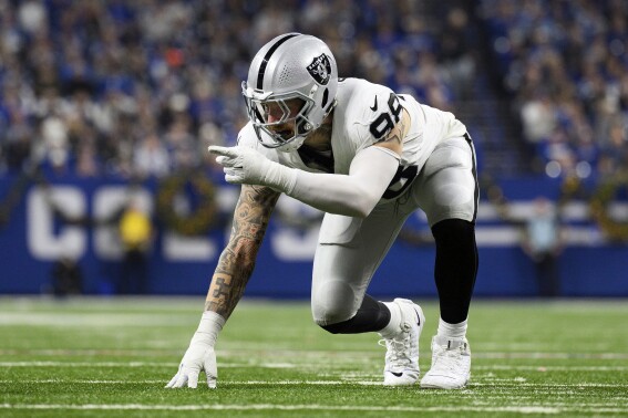 FILE - Las Vegas Raiders defensive end Maxx Crosby (98) lines up before the snap during an NFL football game against the Indianapolis Colts, Dec. 31, 2023, in Indianapolis. Crosby played through the pain of a knee injury much of the 2023 season, usually not practicing so he could play on game days. He said Monday, April 15, 2024, that he is now healthy. (AP Photo/Zach Bolinger, File)