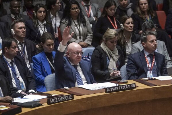 Russia's United Nations Ambassador Vasily Nebenzya raises his hand as he votes against a new U.S. resolution over the conflict between Israel and Palestinians, which was vetoed in the U.N. Security Council, Wednesday, Oct. 25, 2023 at U.N. headquarters. (AP Photo/Bebeto Matthews)