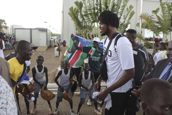 South Sudan basketball player Koch Bar, is welcomed back at Juba International airport, South Sudan, Tuesday, Sept. 5, 2023. Basketball has united the South Sudanese. The country which gained its independence just 12 years ago is still celebrating the men’s national team after its first-ever qualification for the Olympics. South Sudan will play at the Paris Olympics as the automatic qualifier from Africa thanks to a 101-78 win over Angola a week ago at the basketball World Cup in the Philippines. (AP Photo Samir Bol)